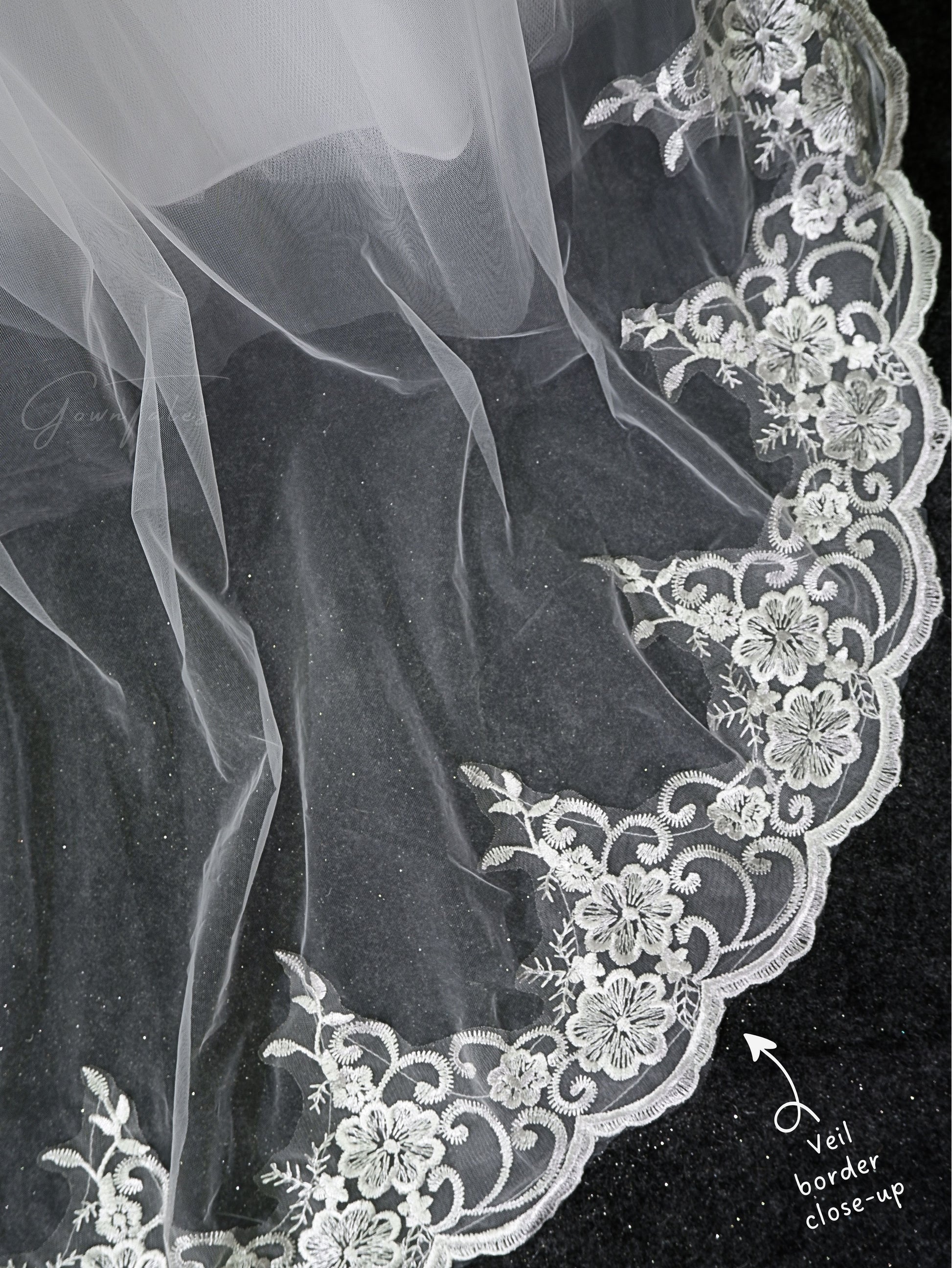 white floor length lace veil border close-up view